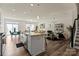 Open floorplan with kitchen, dining and living room, and hardwood style flooring at 6450 Keeton Ln, Harrisburg, NC 28075