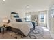 Bright main bedroom with a king bed, white linens, side table, and patterned rug at 6450 Keeton Ln, Harrisburg, NC 28075
