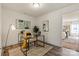 Office with a glass desk, rug, and mirror; bedroom visible through door at 6450 Keeton Ln, Harrisburg, NC 28075