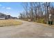 Walking path alongside new townhomes featuring a bench, street and community signage at 6450 Keeton Ln, Harrisburg, NC 28075