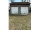 A two-car garage with a weathered exterior offers potential for storage or workshop space at 6520 Farmway Pl, Charlotte, NC 28215