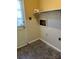 Practical laundry area with direct exterior access; ready for personalization and efficient chore management at 6520 Farmway Pl, Charlotte, NC 28215