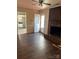 Inviting living room boasts a brick fireplace, hardwood floors, and an open doorway to a modern kitchen at 6520 Farmway Pl, Charlotte, NC 28215