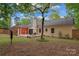 Private backyard featuring a spacious deck, patio furniture, and lush greenery at 6721 Old Post Rd, Charlotte, NC 28212