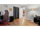 Bright bedroom with hardwood floors featuring a closet and glimpses of another room at 6721 Old Post Rd, Charlotte, NC 28212