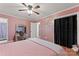 Bedroom featuring wood-look floors, ceiling fan, walk-in closet and vanity with mirror at 6721 Old Post Rd, Charlotte, NC 28212