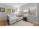 Bright bedroom with hardwood floors and lots of light from the big windows at 6721 Old Post Rd, Charlotte, NC 28212