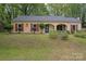 Traditional single-story home with brick facade, red shutters, and lush landscaping at 6721 Old Post Rd, Charlotte, NC 28212