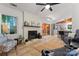 Bright living room features a brick fireplace, ceiling fan, and sliding glass door with access to the backyard at 6721 Old Post Rd, Charlotte, NC 28212