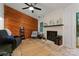 Cozy living room featuring a brick fireplace, wood paneling, and comfortable seating arrangements at 6721 Old Post Rd, Charlotte, NC 28212