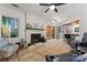 Bright living room features a brick fireplace, ceiling fan, and sliding glass door with access to the backyard at 6721 Old Post Rd, Charlotte, NC 28212