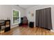 Office space with natural light, wood flooring, and closet at 6721 Old Post Rd, Charlotte, NC 28212