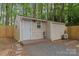 Exterior shot of shed features wood siding, gravel base, and a new door at 6721 Old Post Rd, Charlotte, NC 28212