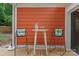 Charming patio setting with bar stools, a table, and vibrant outdoor decor against a vivid backdrop at 6721 Old Post Rd, Charlotte, NC 28212