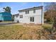 An exterior backyard elevation displays a stone fire pit and a brick exterior of the home at 6914 Idlewild Rd, Charlotte, NC 28212