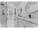 Sleek bathroom featuring marble tile, a double sink vanity, and a glass-enclosed shower at 6914 Idlewild Rd, Charlotte, NC 28212