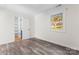 Inviting bedroom features neutral walls, hardwood floors, a window, and closet space at 6914 Idlewild Rd, Charlotte, NC 28212