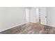 Spacious bedroom featuring neutral walls, hardwood floors, and access to an attached closet at 6914 Idlewild Rd, Charlotte, NC 28212