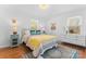 Stylishly decorated bedroom with hardwood floors, two windows and vintage bedside dressers at 6914 Idlewild Rd, Charlotte, NC 28212