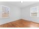 This light and airy bedroom has hardwood floors and natural light from the two large windows at 6914 Idlewild Rd, Charlotte, NC 28212