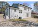An exterior view of a two-story house with white siding, a patio, and a well-maintained backyard at 6914 Idlewild Rd, Charlotte, NC 28212