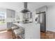 Modern kitchen featuring gray cabinetry, stainless steel appliances, and a large island with bar seating at 6914 Idlewild Rd, Charlotte, NC 28212