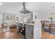 Open-concept kitchen and living space featuring stainless steel appliances, a center island, and a cozy seating area at 6914 Idlewild Rd, Charlotte, NC 28212