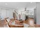 Open-concept living space blending the kitchen and living area, featuring stairs and a view of the front entrance at 6914 Idlewild Rd, Charlotte, NC 28212