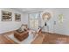 Cozy living room with woven chairs, area rug, and ample natural light from the front window at 6914 Idlewild Rd, Charlotte, NC 28212
