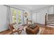 Bright living room with a statement mirror, woven chairs, and view of the entry at 6914 Idlewild Rd, Charlotte, NC 28212