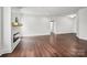 Large living area with dark wood floors, a modern fireplace, and wainscoting at 719 S Franklin St # 2, China Grove, NC 28023