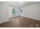 Well-lit bedroom featuring hardwood floors and multiple exterior doors at 775 Bridgewood Dr, Rock Hill, SC 29732