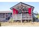 Back porch with stylish egg chairs, red curtains, and a cozy hangout spot at 7930 Browne Rd, Charlotte, NC 28269