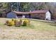 Beautiful home featuring stone and vinyl siding, a well-manicured lawn, and mature landscaping at 7930 Browne Rd, Charlotte, NC 28269