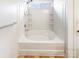 Bathroom with a large white bathtub and tiled walls and floors at 8005 Mcgarry Trl, Charlotte, NC 28214