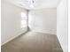 Bedroom with a neutral carpet, a ceiling fan with a light, one window, and an electrical outlet at 8005 Mcgarry Trl, Charlotte, NC 28214