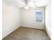 Bedroom with a neutral carpet, a ceiling fan with a light, one window, and an electrical outlet at 8005 Mcgarry Trl, Charlotte, NC 28214