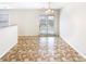 Bright dining area featuring neutral walls, tiled floors, and a glass door leading to the outside at 8005 Mcgarry Trl, Charlotte, NC 28214