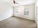 Large carpeted main bedroom with a ceiling fan and two windows providing natural light at 8005 Mcgarry Trl, Charlotte, NC 28214