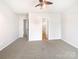 Spacious carpeted main bedroom with two doors leading to other rooms and carpeted flooring at 8005 Mcgarry Trl, Charlotte, NC 28214