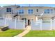 View of the home's backyard with white fence for privacy at 8009 Whitehawk Hill Rd, Waxhaw, NC 28173