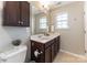 Bathroom featuring updated vanity, mirror, and natural light from the window at 8009 Whitehawk Hill Rd, Waxhaw, NC 28173