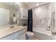 Bathroom with a tub and shower combination features updated white vanity and neutral color palette at 8009 Whitehawk Hill Rd, Waxhaw, NC 28173