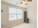 Bedroom features neutral walls, soft carpet, a ceiling fan, and natural light at 8009 Whitehawk Hill Rd, Waxhaw, NC 28173