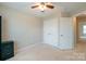 Bedroom features neutral walls, soft carpet, a ceiling fan, and double closets at 8009 Whitehawk Hill Rd, Waxhaw, NC 28173