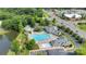 Aerial view of community pool with waterslide, mature trees, pond, clubhouse and surrounding streets at 8009 Whitehawk Hill Rd, Waxhaw, NC 28173
