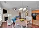 Open concept dining and living area with a fireplace, ceiling fan, and a view of the kitchen at 8009 Whitehawk Hill Rd, Waxhaw, NC 28173