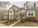 Inviting townhome with stone accents, manicured landscaping, and covered entryways, creating curb appeal at 8009 Whitehawk Hill Rd, Waxhaw, NC 28173