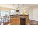 Modern kitchen with breakfast bar, stainless steel sink and appliances, open to dining and living area at 8009 Whitehawk Hill Rd, Waxhaw, NC 28173