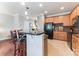 Well-lit kitchen with dark appliances, tiled floor and wooden cabinetry at 8009 Whitehawk Hill Rd, Waxhaw, NC 28173